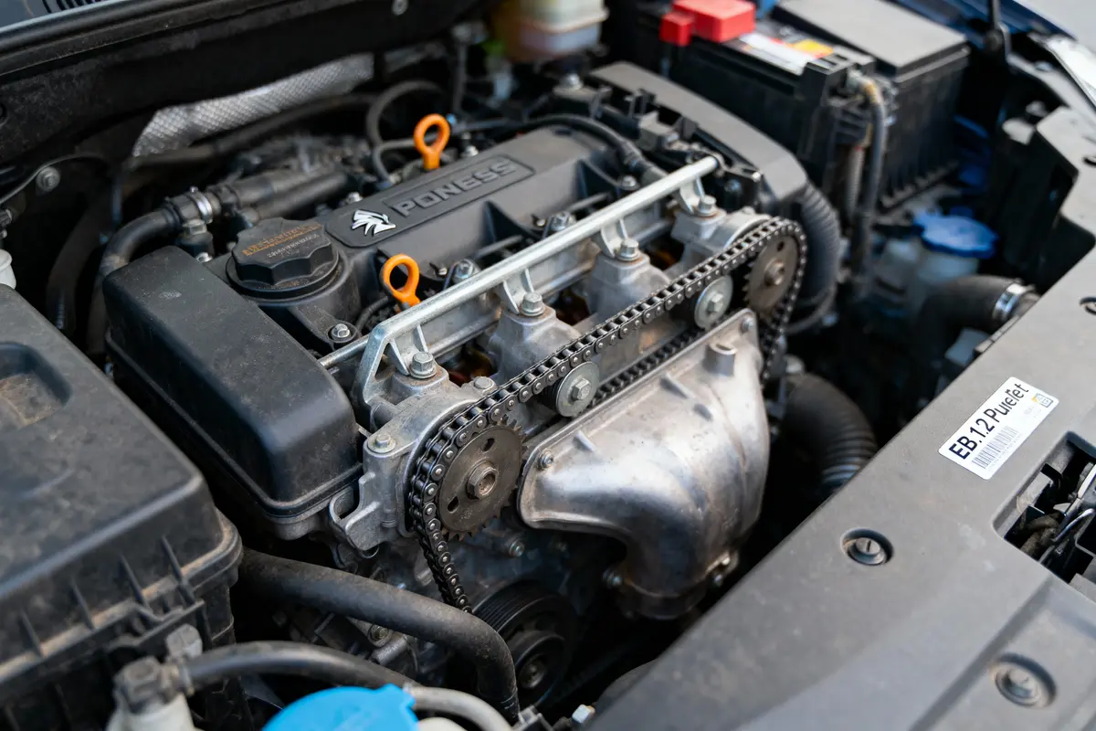 Moteur de voiture EB2 PureTech avec chaînes et composants visibles sous le capot noir.