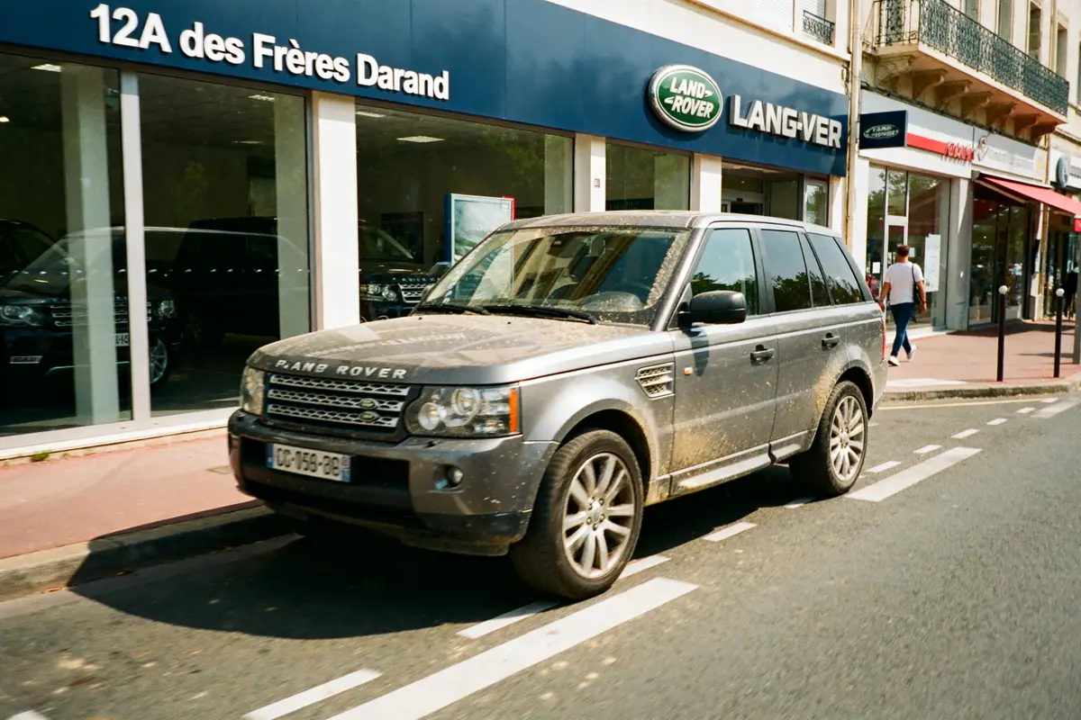 Land Rover devant concession à Vénissieux avec vitrine visible en arrière-plan