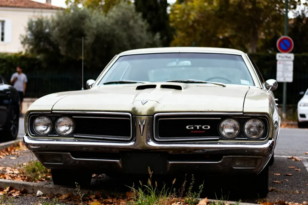 Voiture classique Pontiac GTO auto garée sur une route bordée de feuilles d'automne